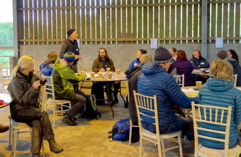 Farmers in a barn talking